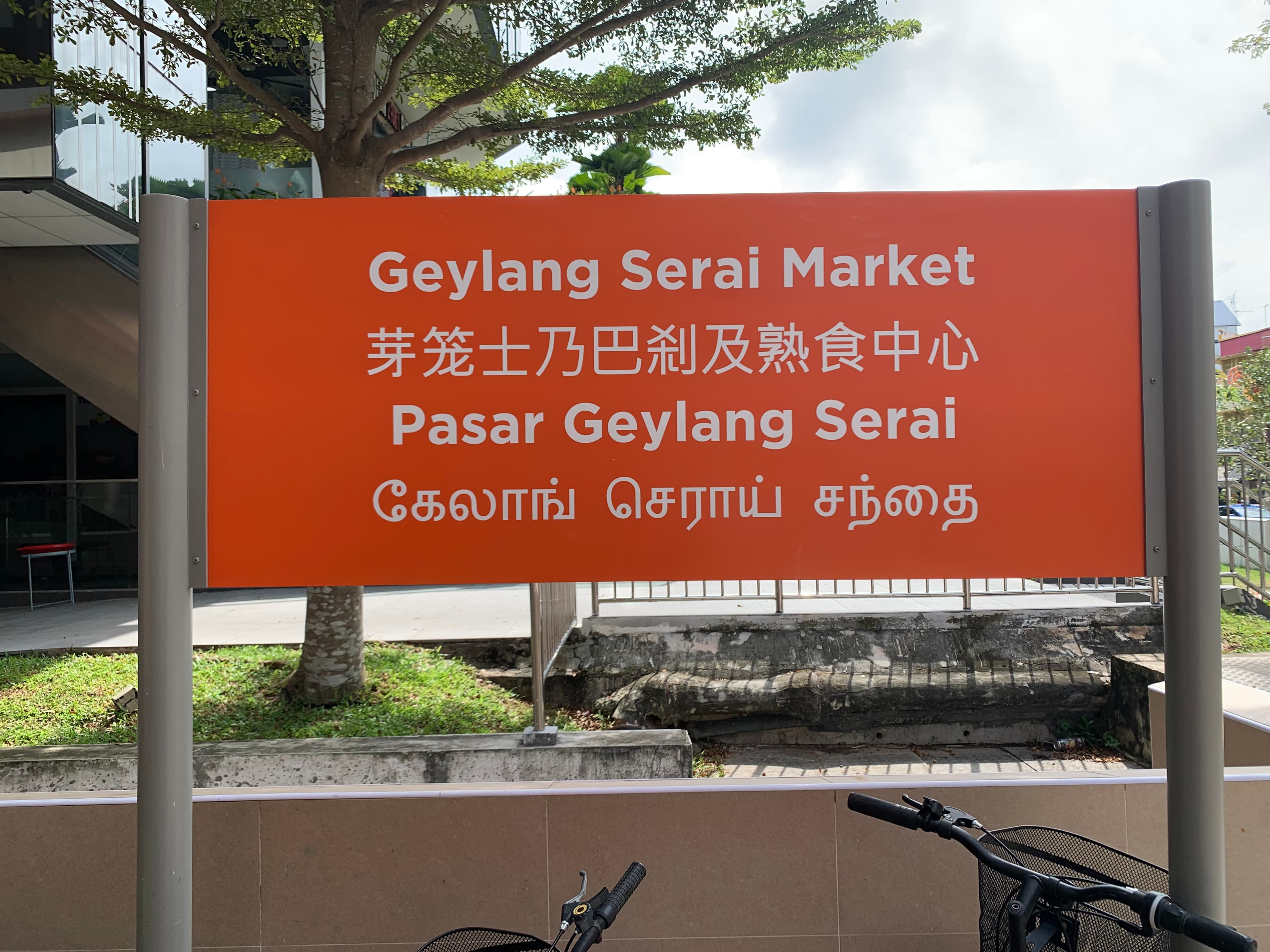 A Singapore market sign written in English, Chinese, Malay and Tamil