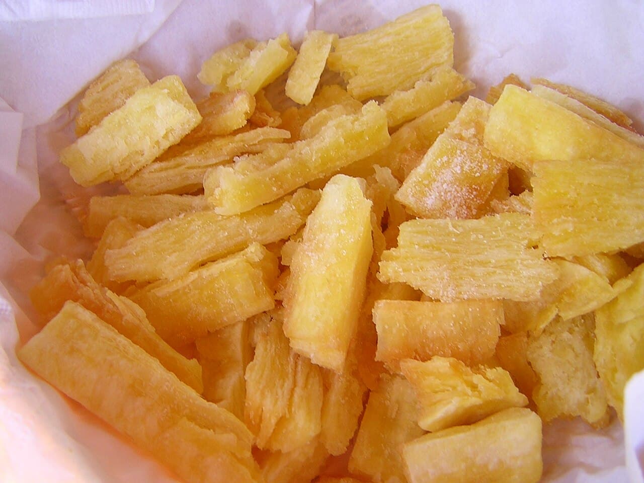 Golden crispy yuca frita served with curtido and chicharr贸n