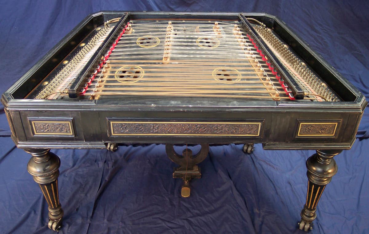 A musician playing a cimbalom with small hammers at a Hungarian folk concert