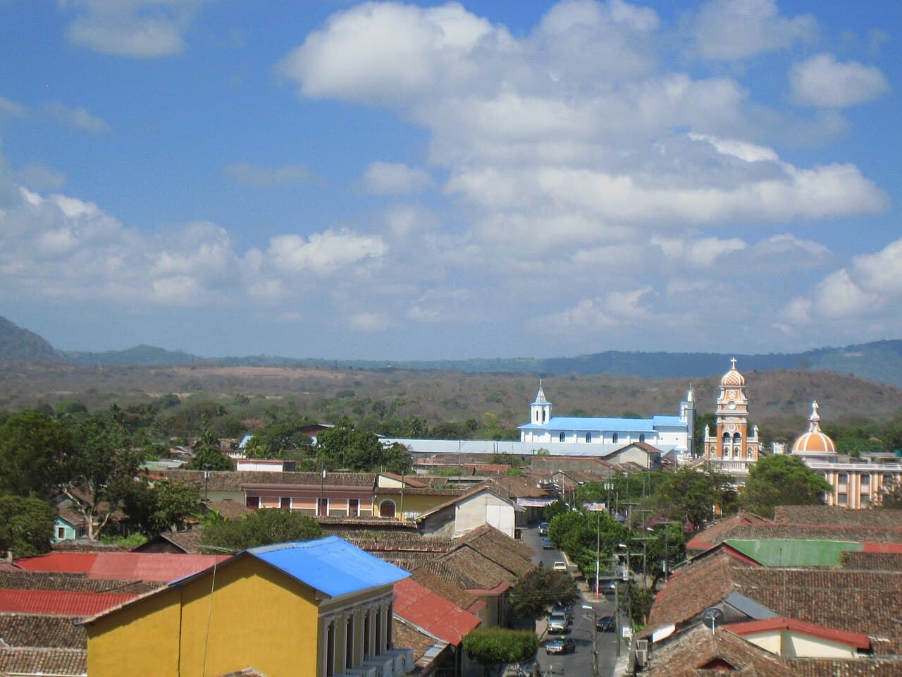 Brightly painted colonial buildings lining a cobblestone street in Granada, Nicaragua