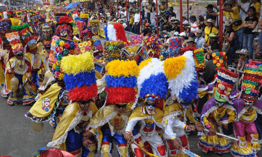 Dancers in colourful feathered costumes parading at the Las Tablas Carnival