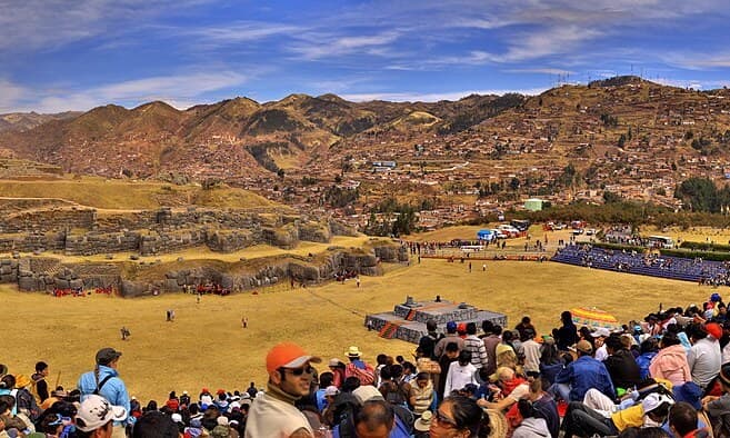 A wide view of crowds gathered at Sacsayhuam谩n above Cusco for Inti Raymi