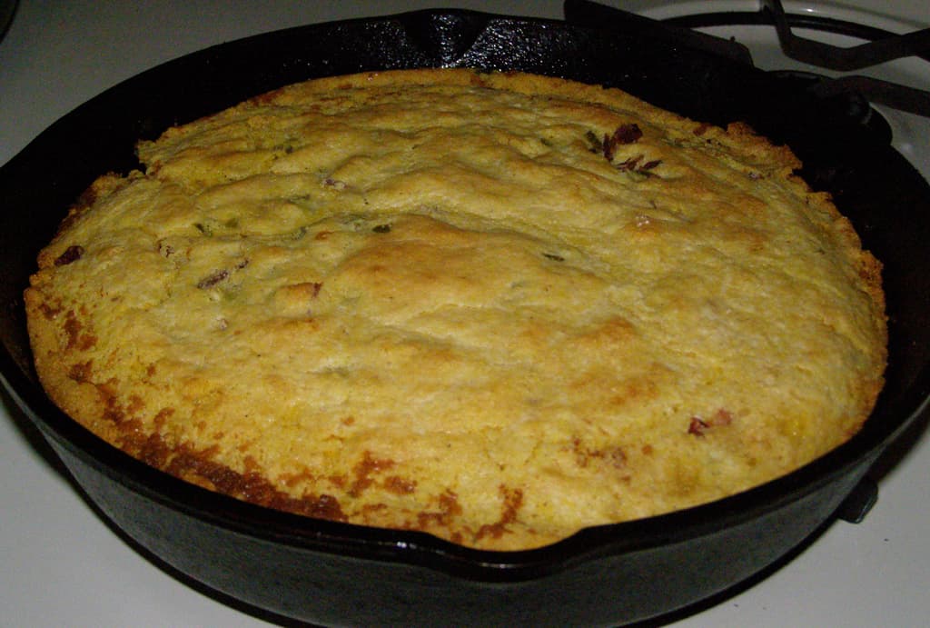A square of golden proja Serbian cornbread on a wooden board