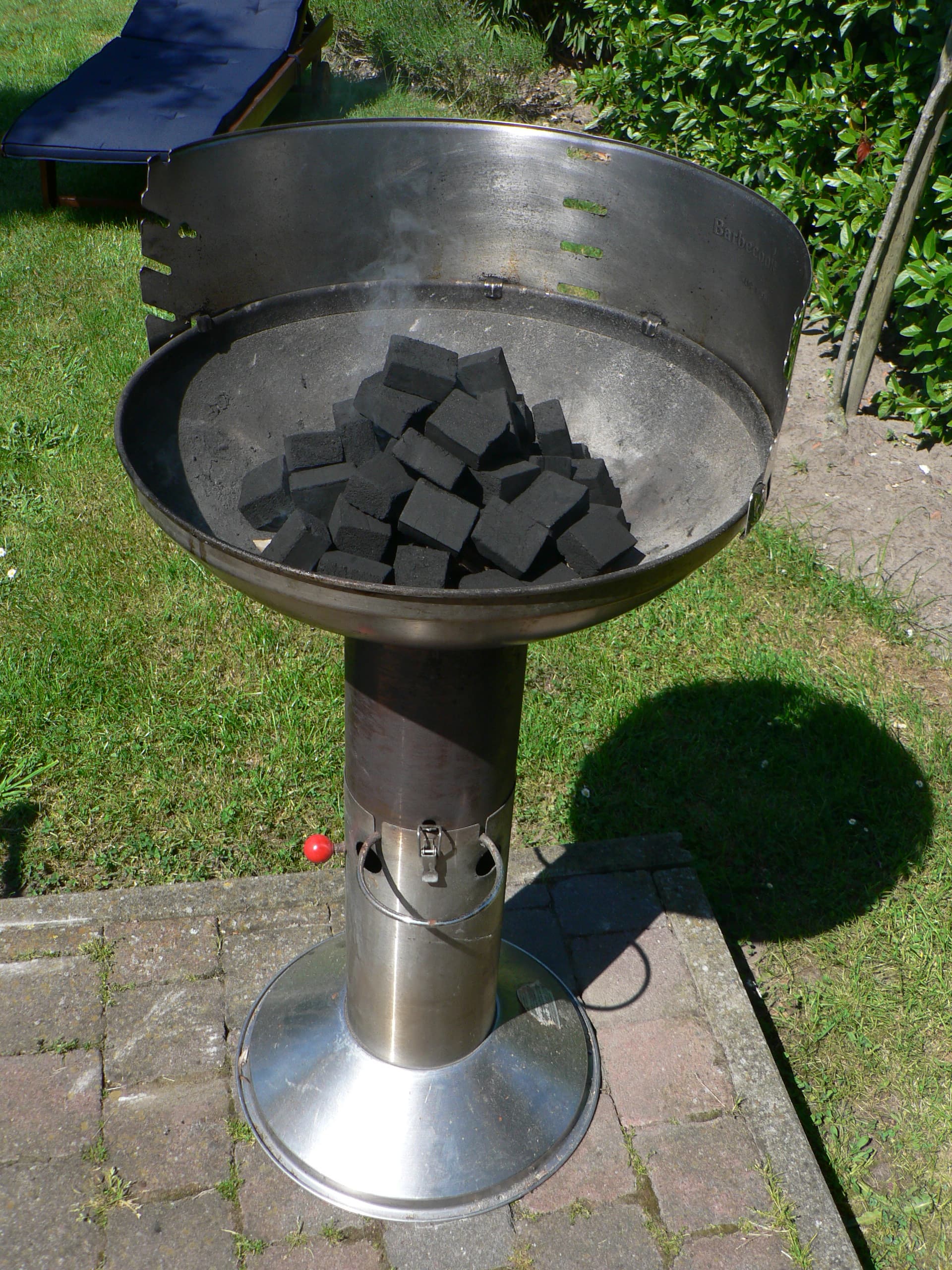 Ribs and sausages grilling over hot coals on a traditional Uruguayan parrilla
